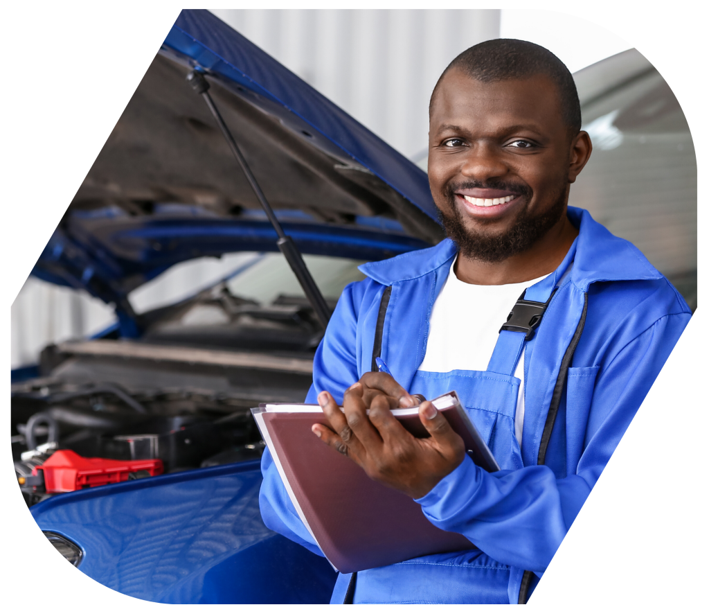 African mechanic in blue overalls