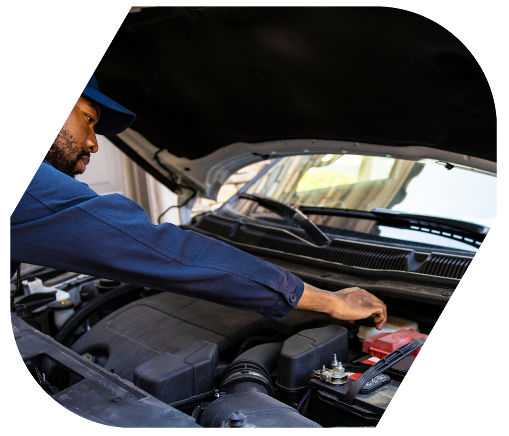 african mechanic fixing car engine